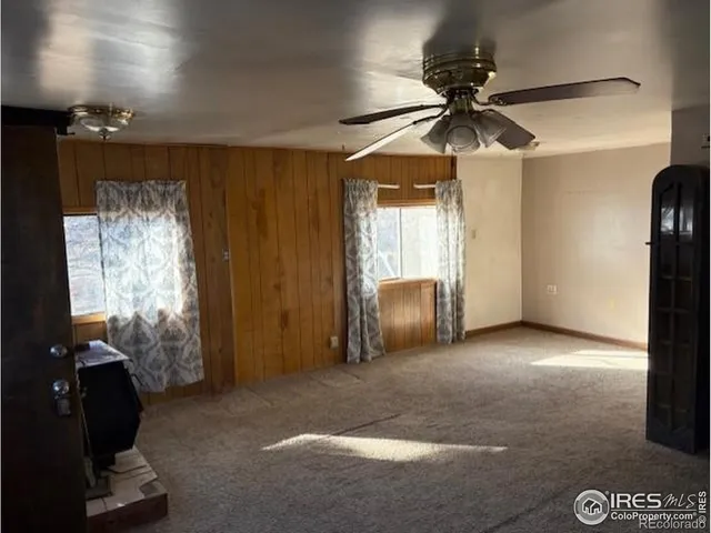 a view of a livingroom with a ceiling fan and window