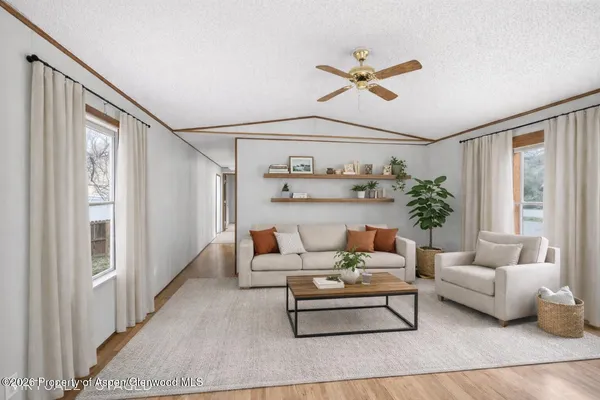 a living room with furniture and white walls