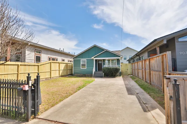 a front view of a house with wooden fence