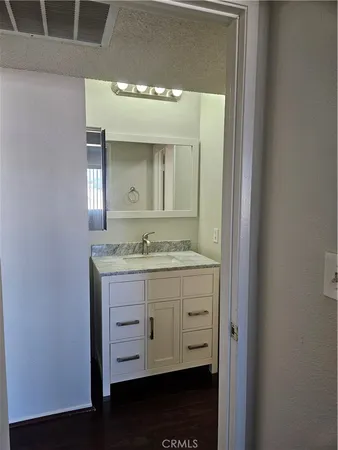 a bathroom with a granite countertop sink a mirror and a