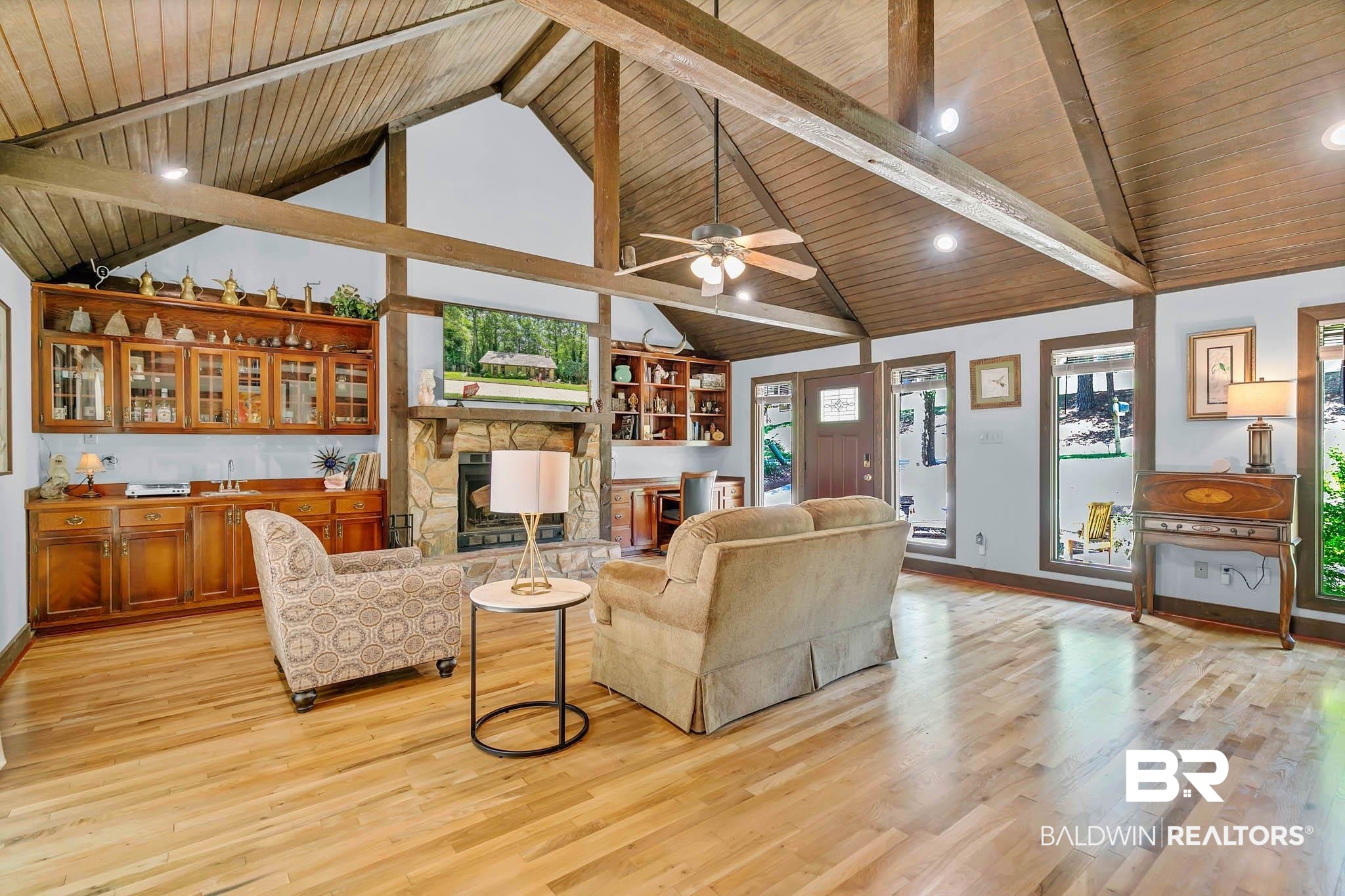 332 Ridgewood Drive Daphne, AL 36526 - Photo 10 of 48 Living area with light wood finished floors, healthy amount of natural light, a stone fireplace, high vaulted ceiling, and a wood ceiling with exposed beams