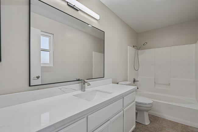 2240 Preston Court Hollister, CA 95023 - Photo 15 of 21 a bathroom with a granite countertop sink a toilet and a bathtub