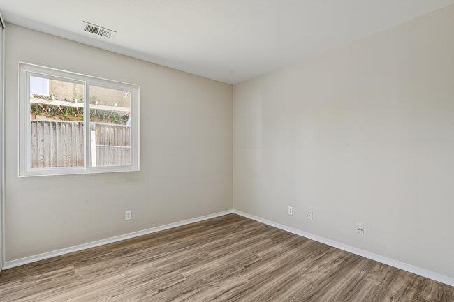 2240 Preston Court Hollister, CA 95023 - Photo 16 of 21 an empty room with wooden floor and windows