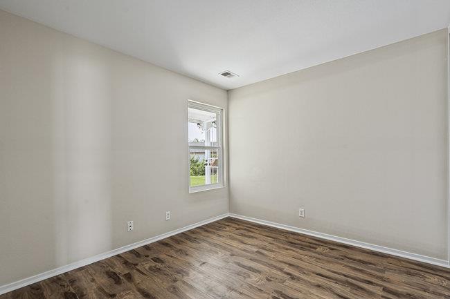 2240 Preston Court Hollister, CA 95023 - Photo 17 of 21 a view of an empty room with wooden floor and a window