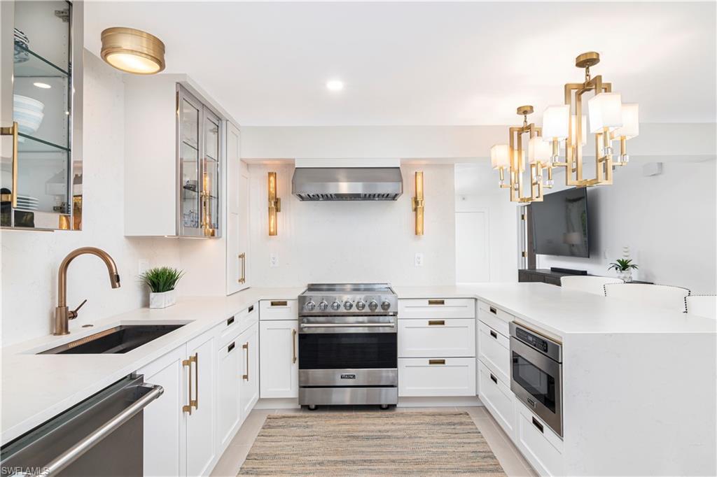 1222 Gordon Drive, Unit 4 Naples, FL 34102 - Photo 1 of 20 a kitchen with a stove and a sink