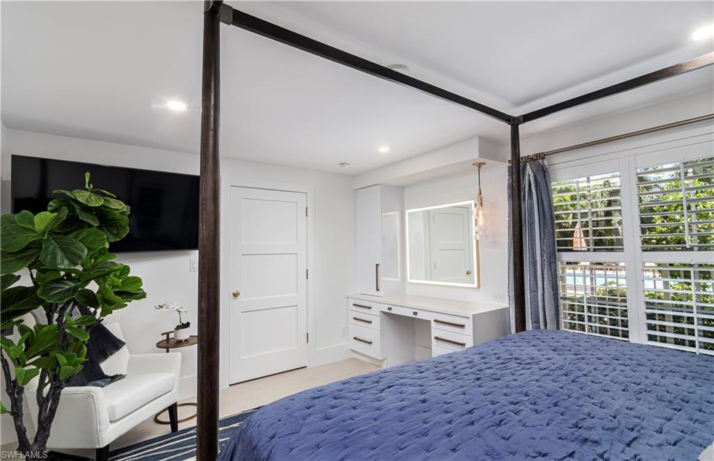 1222 Gordon Drive, Unit 4 Naples, FL 34102 - Photo 11 of 20 a spacious bedroom with a bed and a potted plant