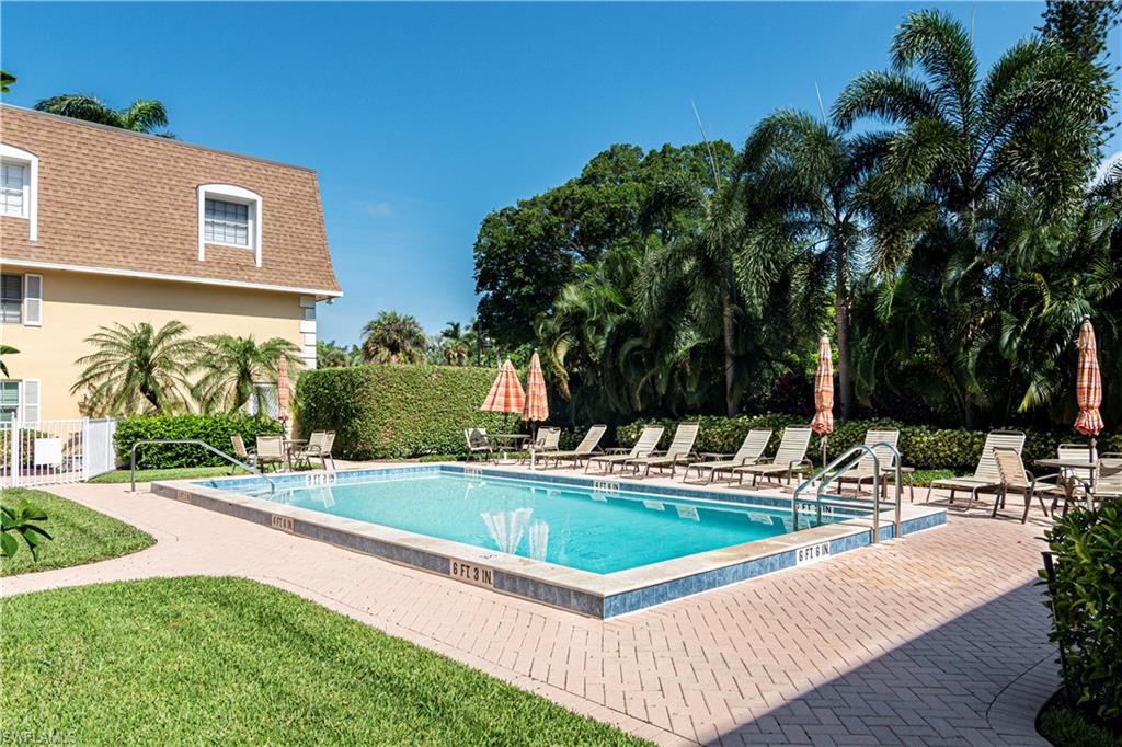 1222 Gordon Drive, Unit 4 Naples, FL 34102 - Photo 19 of 20 a view of a house with swimming pool and sitting area