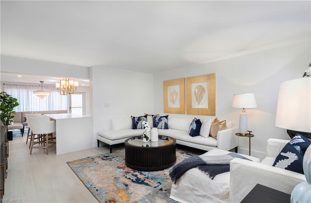 1222 Gordon Drive, Unit 4 Naples, FL 34102 - Photo 4 of 20 a living room with furniture and a lamp