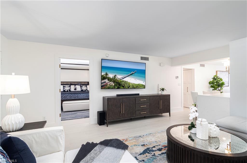 1222 Gordon Drive, Unit 4 Naples, FL 34102 - Photo 5 of 20 a living room with furniture and a flat screen tv