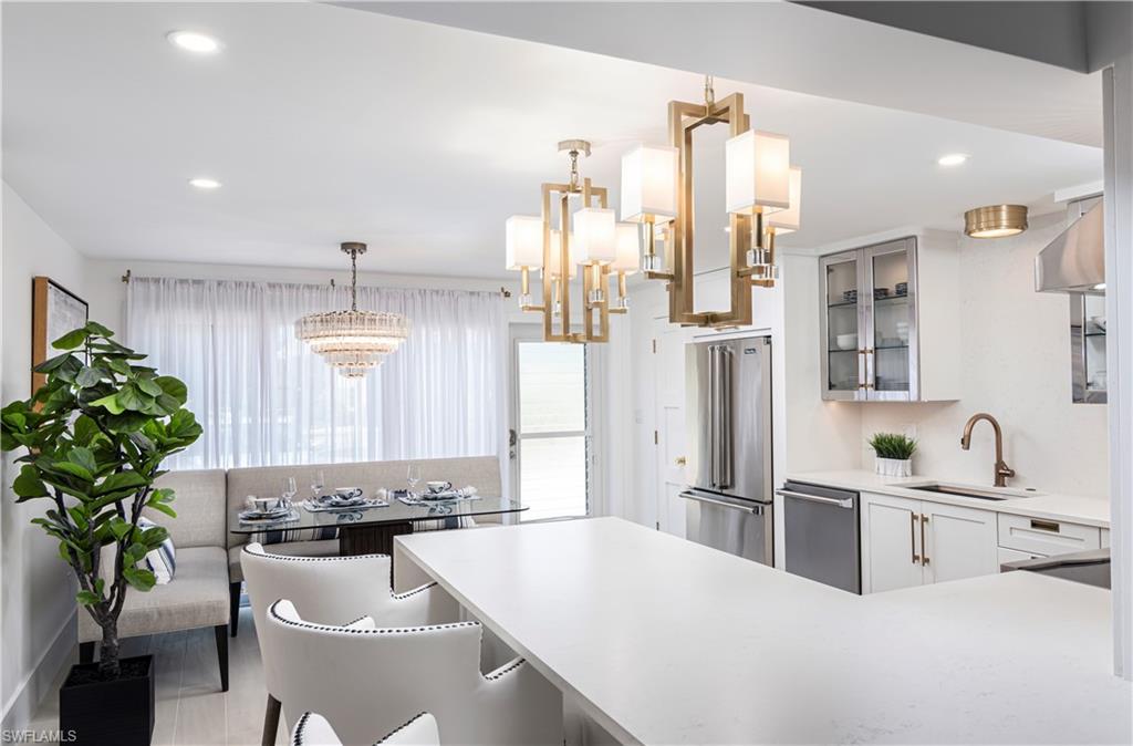 1222 Gordon Drive, Unit 4 Naples, FL 34102 - Photo 6 of 20 a large kitchen with granite countertop a sink stainless steel appliances and cabinets