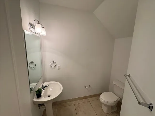 a bathroom with a sink toilet and a mirror