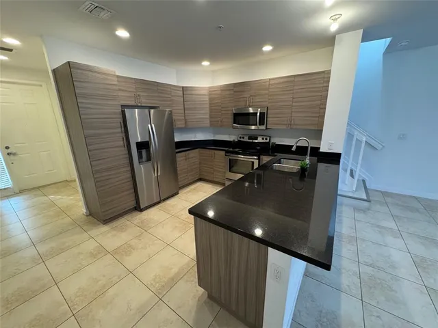 a kitchen with stainless steel appliances granite countertop a sink and cabinets