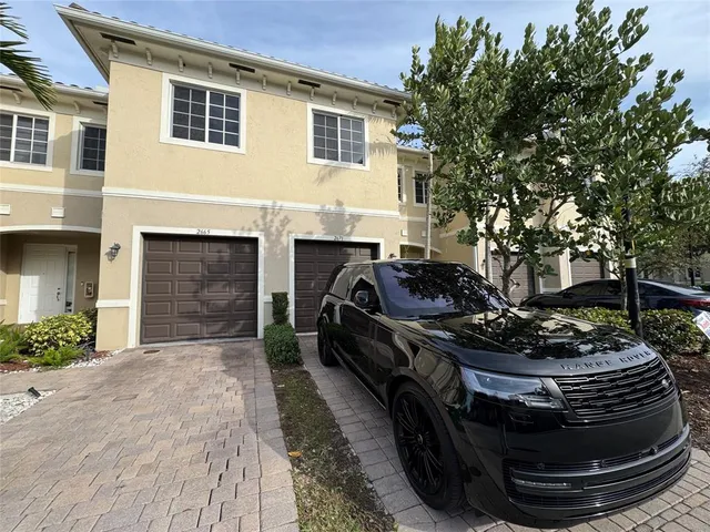 a view of a house with a yard and furniture