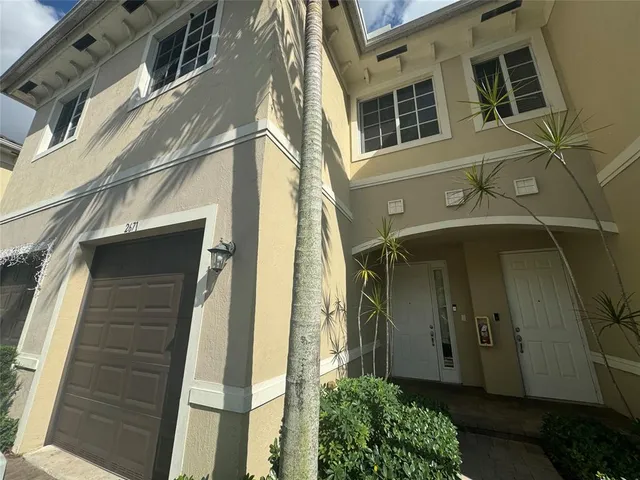a view of a brick house with many windows