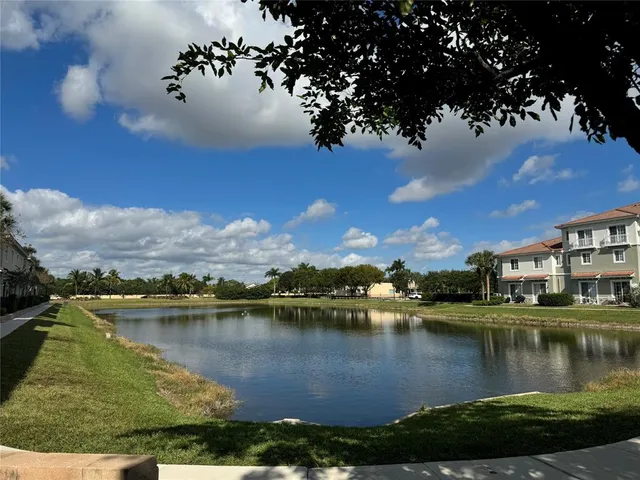 a view of a lake with houses in the back