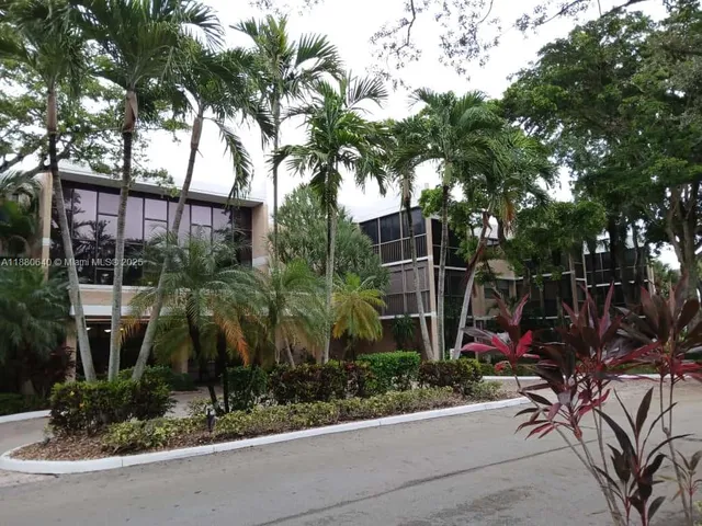 a backyard of a house with lots of plants and trees