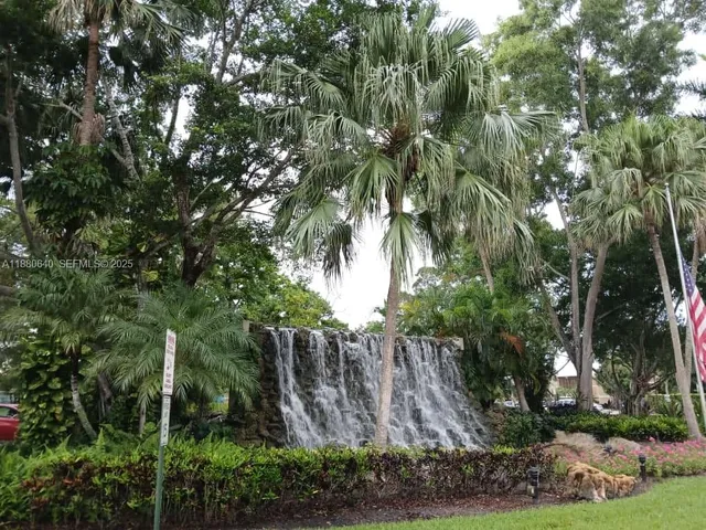 a backyard of a house with lots of plants and trees