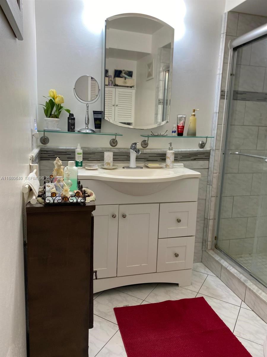 16325 Golf Club Road, Unit 102 Weston, FL 33326 - Photo 13 of 21 a bathroom with a sink vanity and mirror