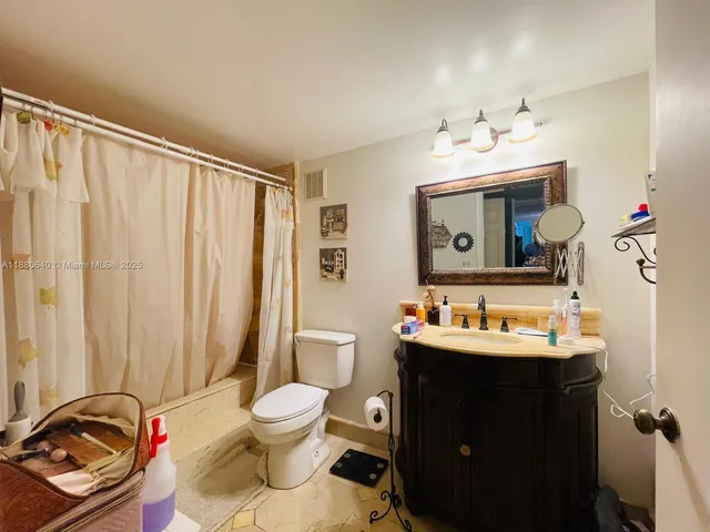 a bathroom with a sink vanity and mirror