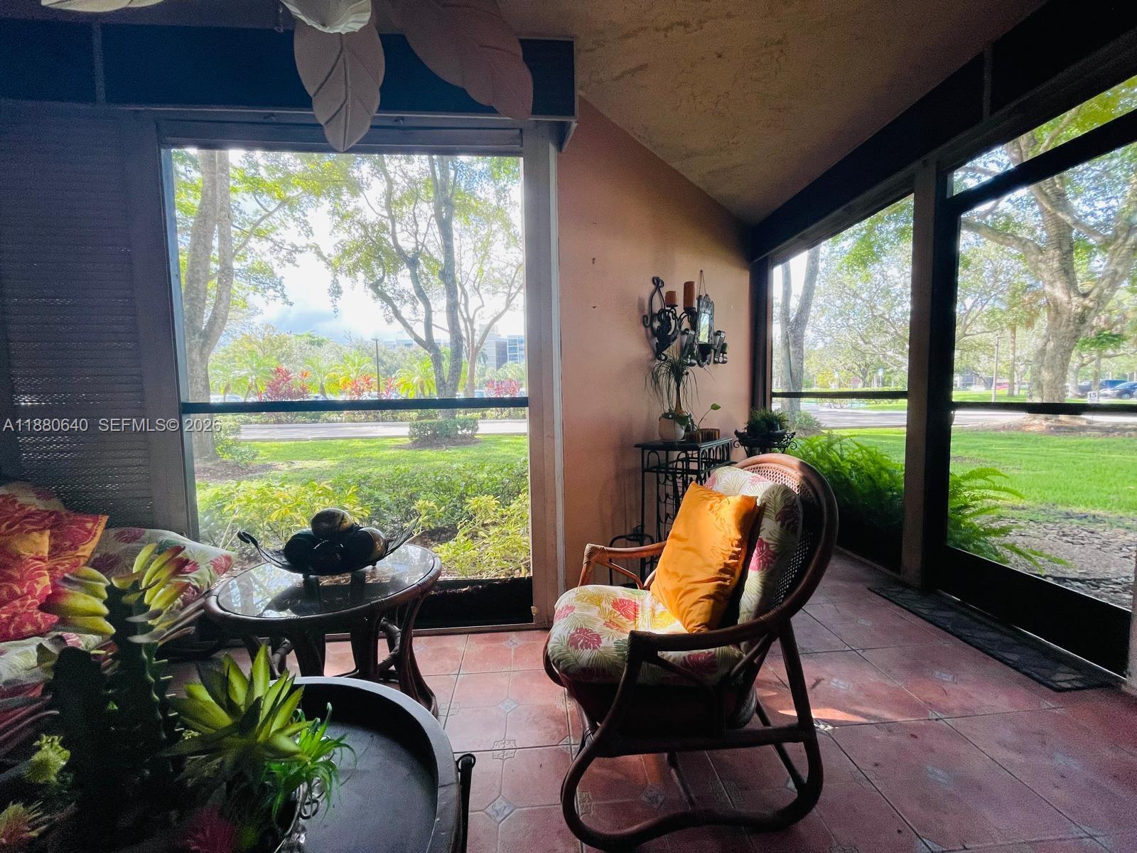 16325 Golf Club Road, Unit 102 Weston, FL 33326 - Photo 15 of 21 a outdoor living space with furniture and a potted plant