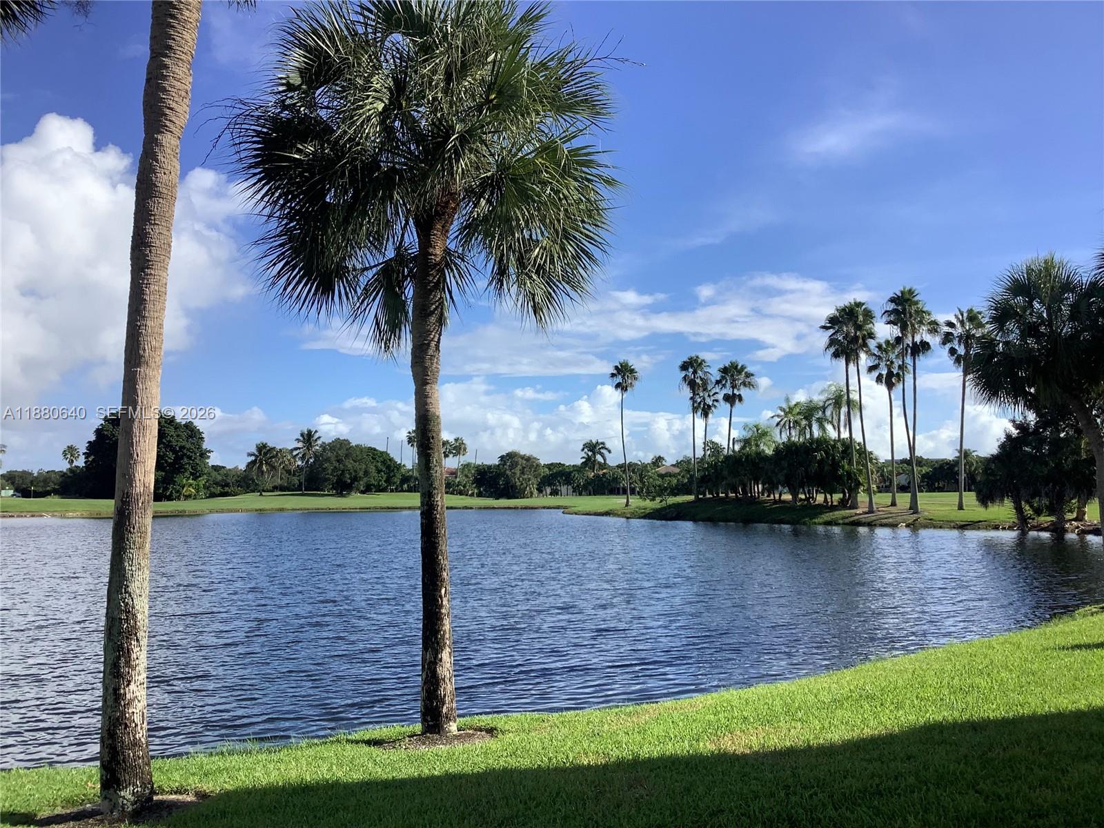 16325 Golf Club Road, Unit 102 Weston, FL 33326 - Photo 21 of 21 a view of a lake with a building in the background