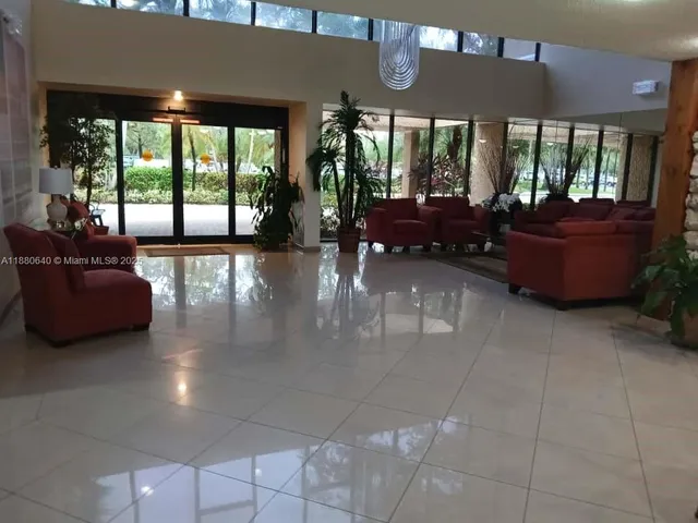 a kitchen with stainless steel appliances granite countertop a refrigerator a stove and a sink