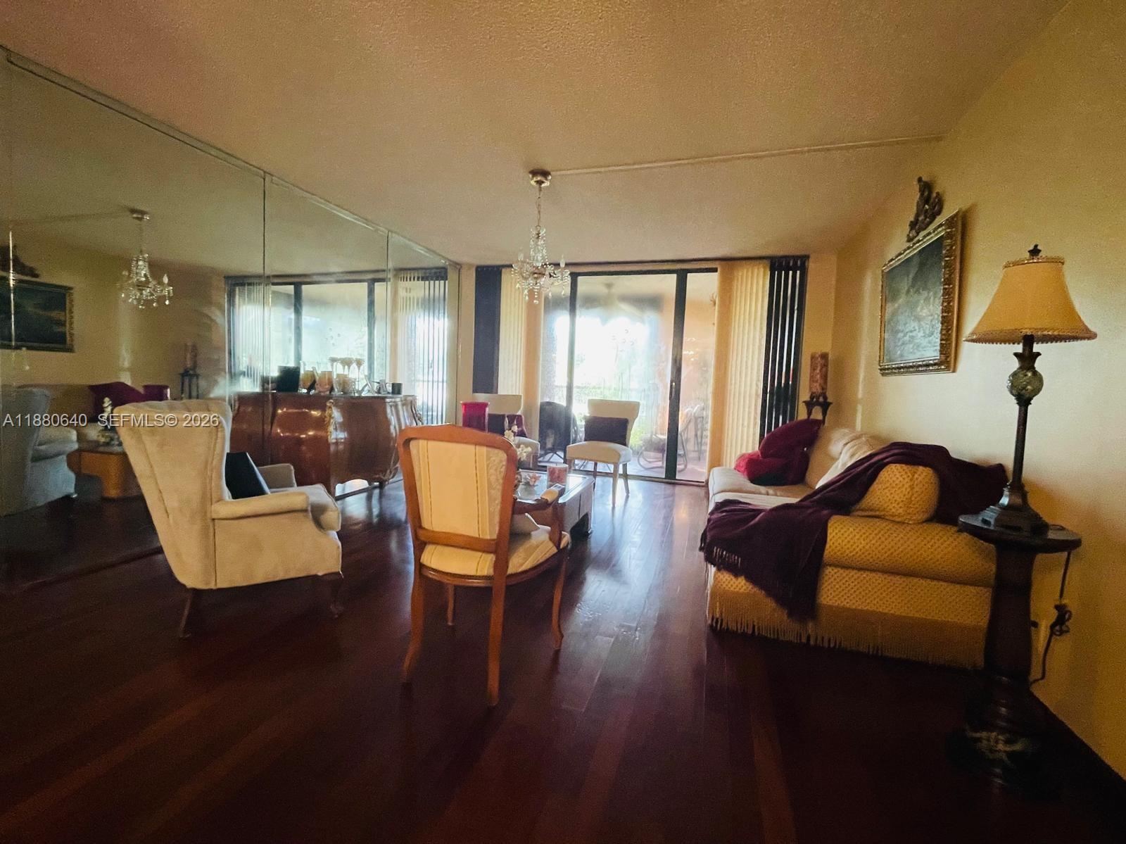 16325 Golf Club Road, Unit 102 Weston, FL 33326 - Photo 4 of 21 a living room with furniture and a lamp