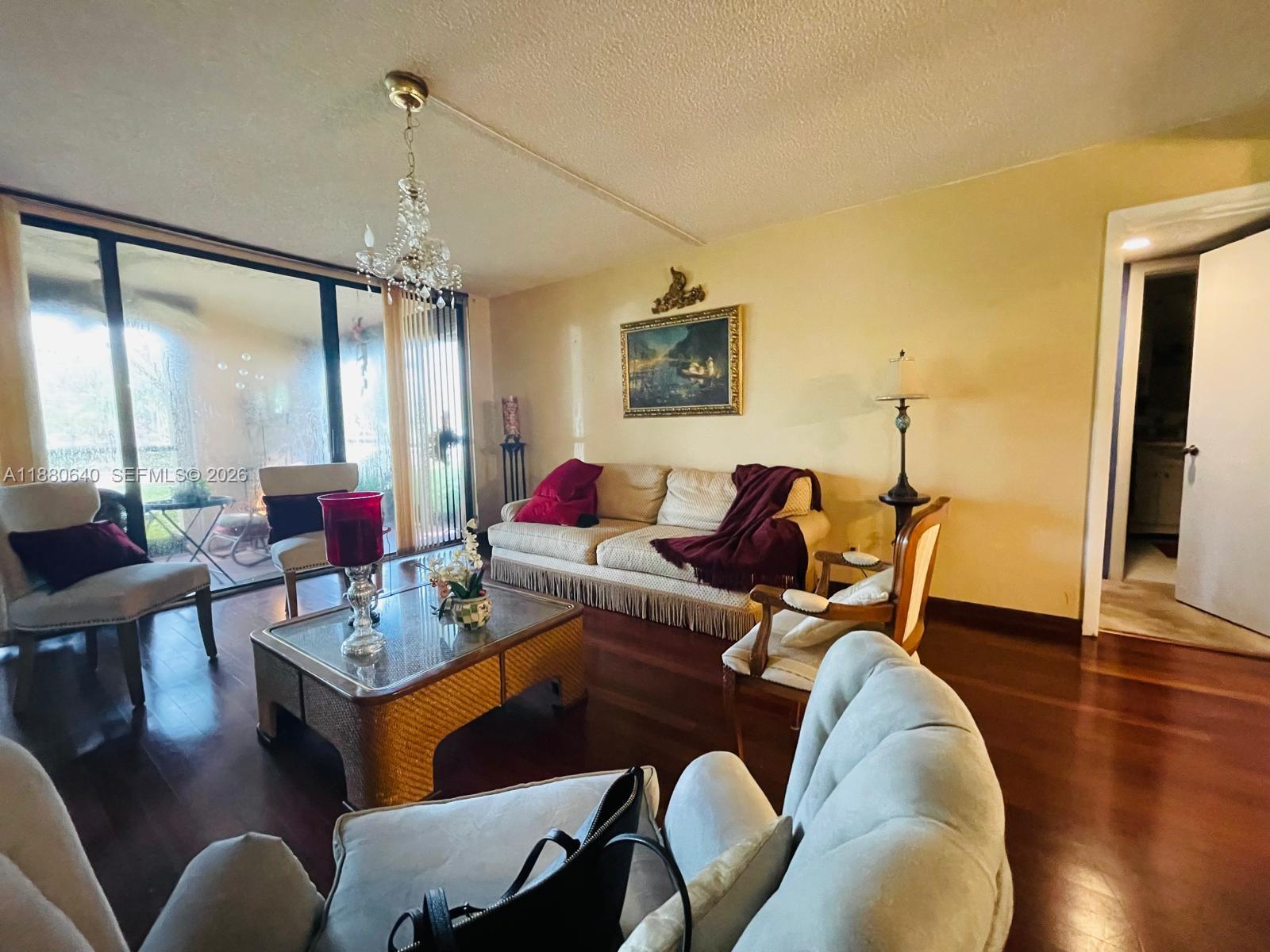 16325 Golf Club Road, Unit 102 Weston, FL 33326 - Photo 5 of 21 a living room with furniture and wooden floor