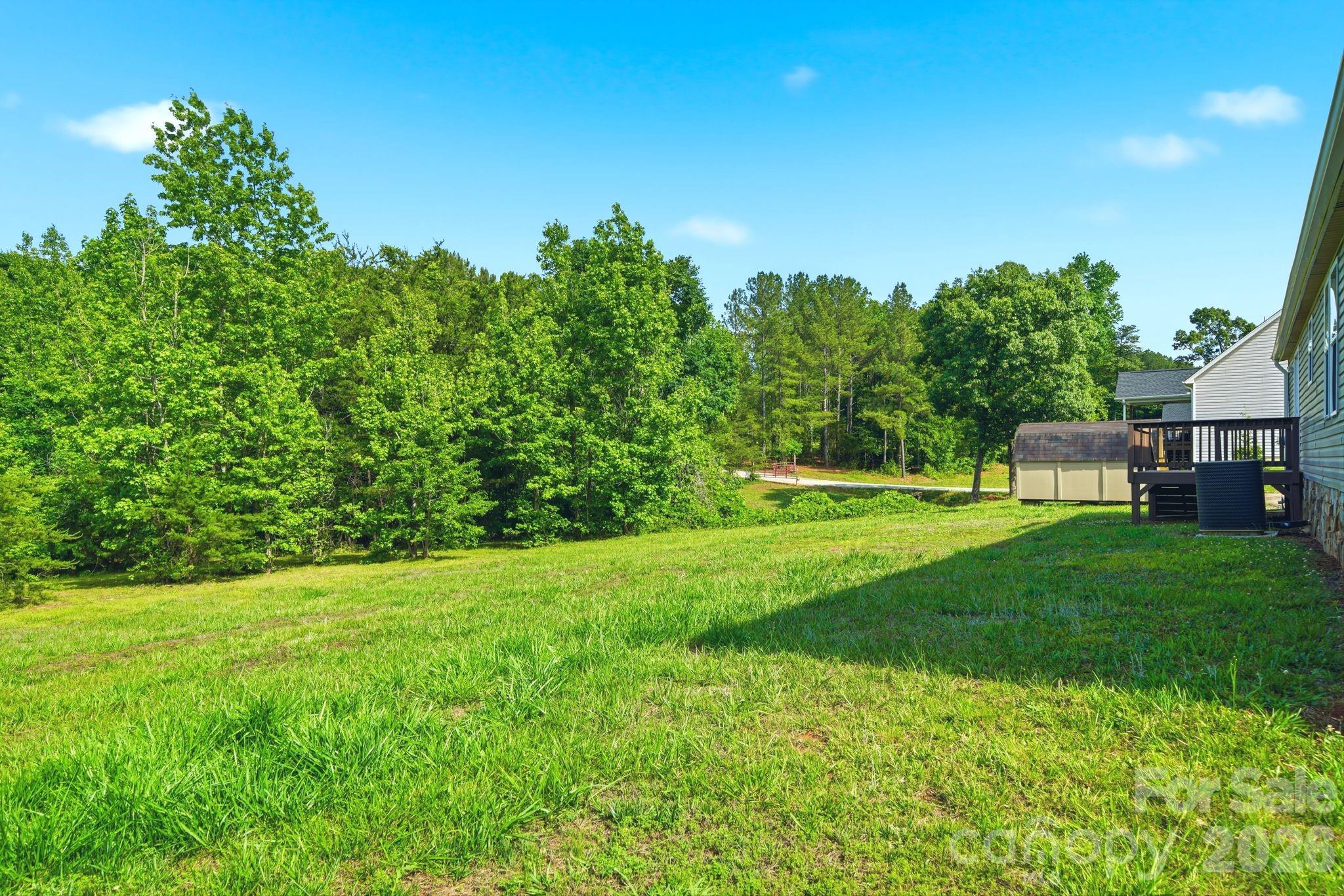 2368 Beth Haven Church Road Denver, NC 28037 - Photo 38 of 42 a view of a grassy field with trees in the background