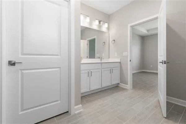 a view of a bathroom with mirror and sink