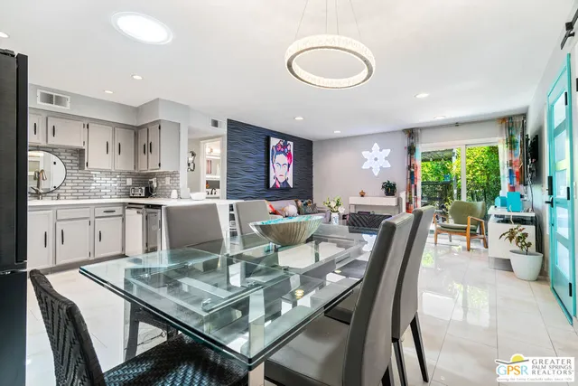 a utility room with stainless steel appliances granite countertop a stove and a refrigerator
