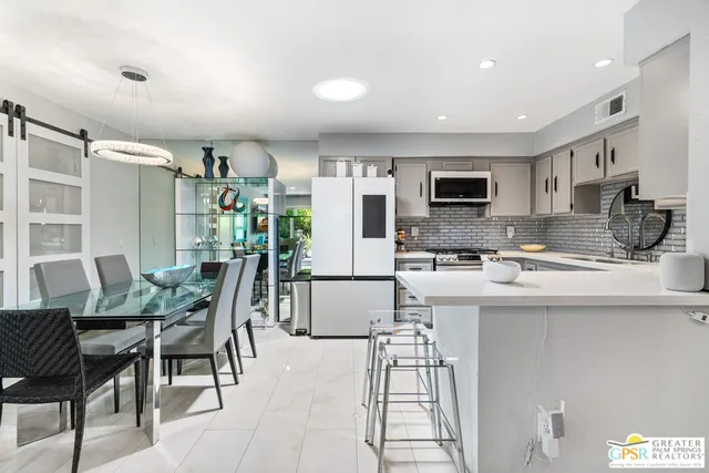 a kitchen with stainless steel appliances a stove refrigerator sink and microwave