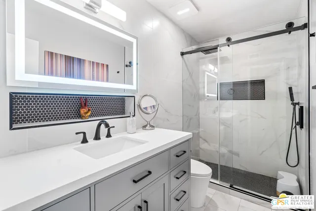 a bedroom with a bed and a tv on the dresser