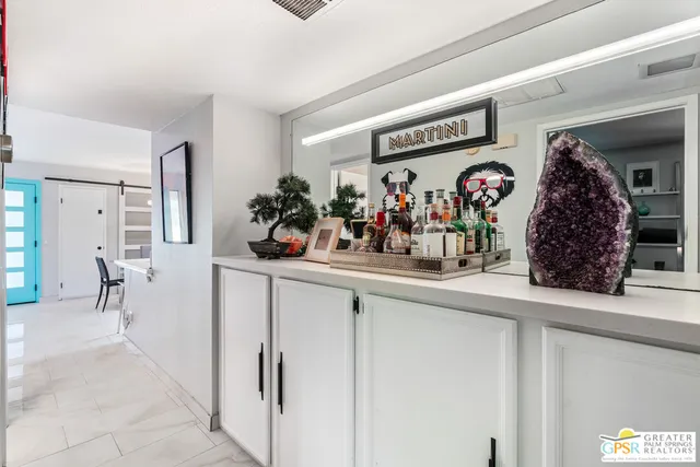 a bed sitting in a bedroom next to a large window