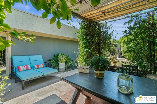 a view of a backyard with seating area