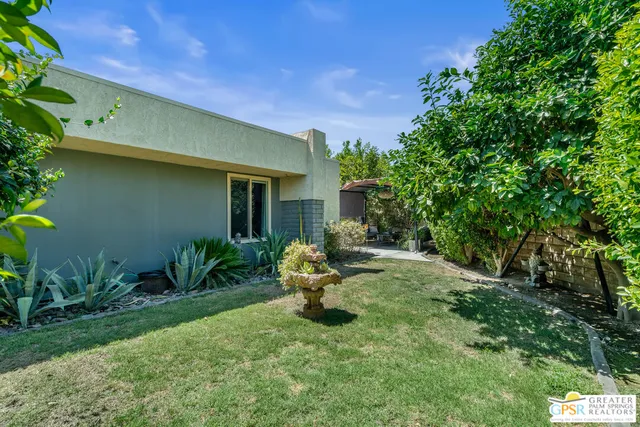 a backyard of a house with outdoor seating