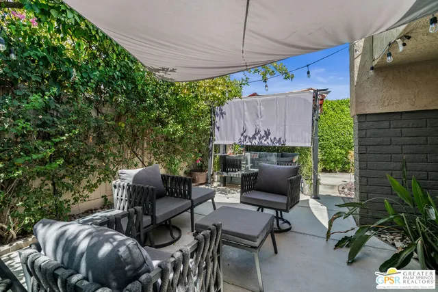 a view of a house with swimming pool and sitting area