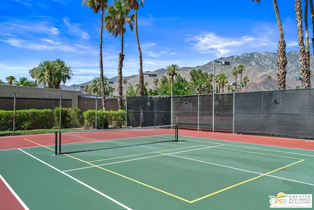 a view of a swimming pool with an outdoor seating and a yard