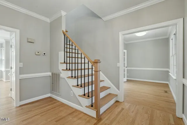 a kitchen with stainless steel appliances granite countertop a refrigerator a sink a oven and a wooden floors