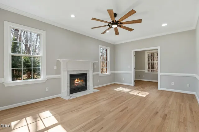 a kitchen with stainless steel appliances granite countertop a sink a stove and wooden floor