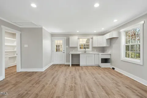 a view of kitchen with wooden floor and electronic appliances