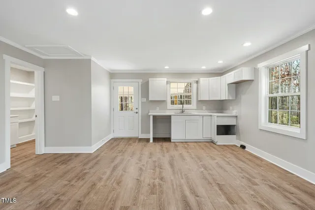 a view of kitchen with wooden floor and electronic appliances