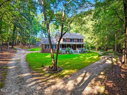 a front view of a house with a yard table and chairs