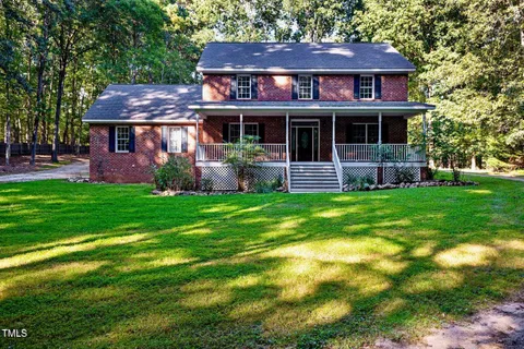 a front view of a house with a garden and porch