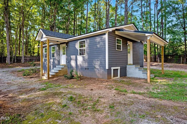a front view of a house with a garden and porch