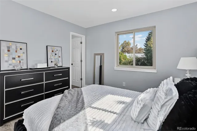 a bedroom with a bed and a view of kitchen