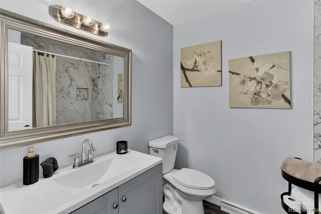 a bathroom with a toilet and a shower curtain