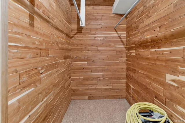 a view of an empty room with wooden floor and window