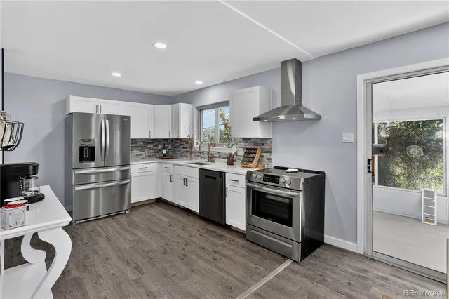 a kitchen with stainless steel appliances a refrigerator and a stove top oven