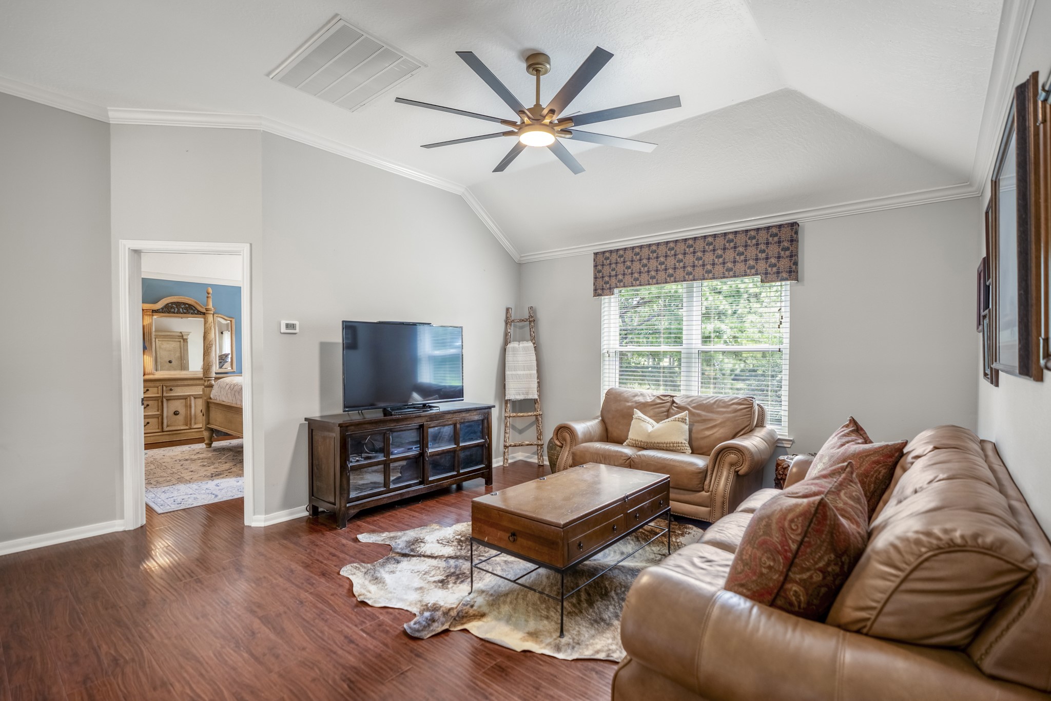 20235 Eden Pines Spring, TX 77379 - Photo 18 of 50 At the top of the stairs, the game room immediately gives the second floor another place to settle in—perfect for movie nights, game days or simply spreading out away from the main living room downstairs. A large window fills the space with natural light, while the sculptural ceiling fan adds a cool design detail overhead. Just through the doorway on the left is the primary suite, which is where the tour heads next.
